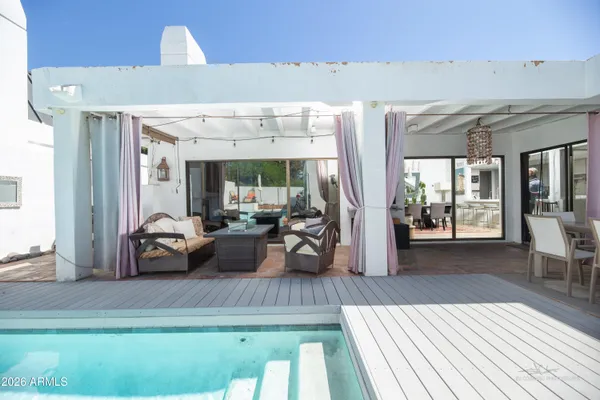 a view of a dining room with furniture and chandelier