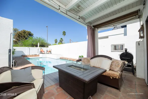 a view of a house with a swimming pool and a patio