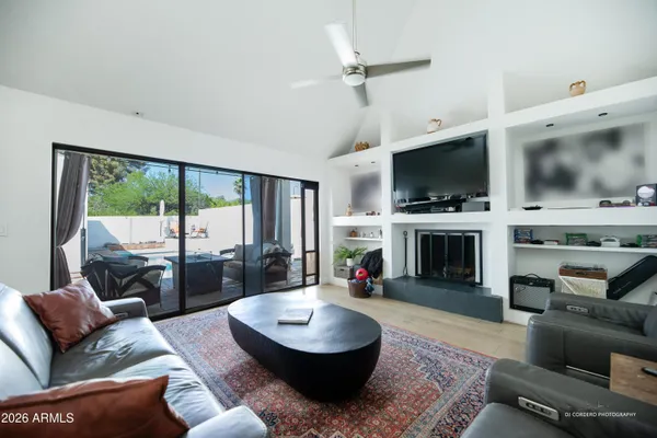 a living room with furniture a fireplace and a flat screen tv