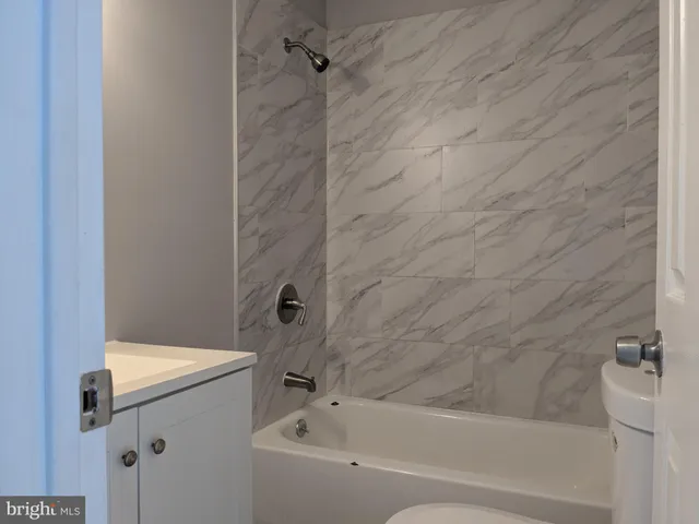 a bathroom with a sink a toilet and bathtub