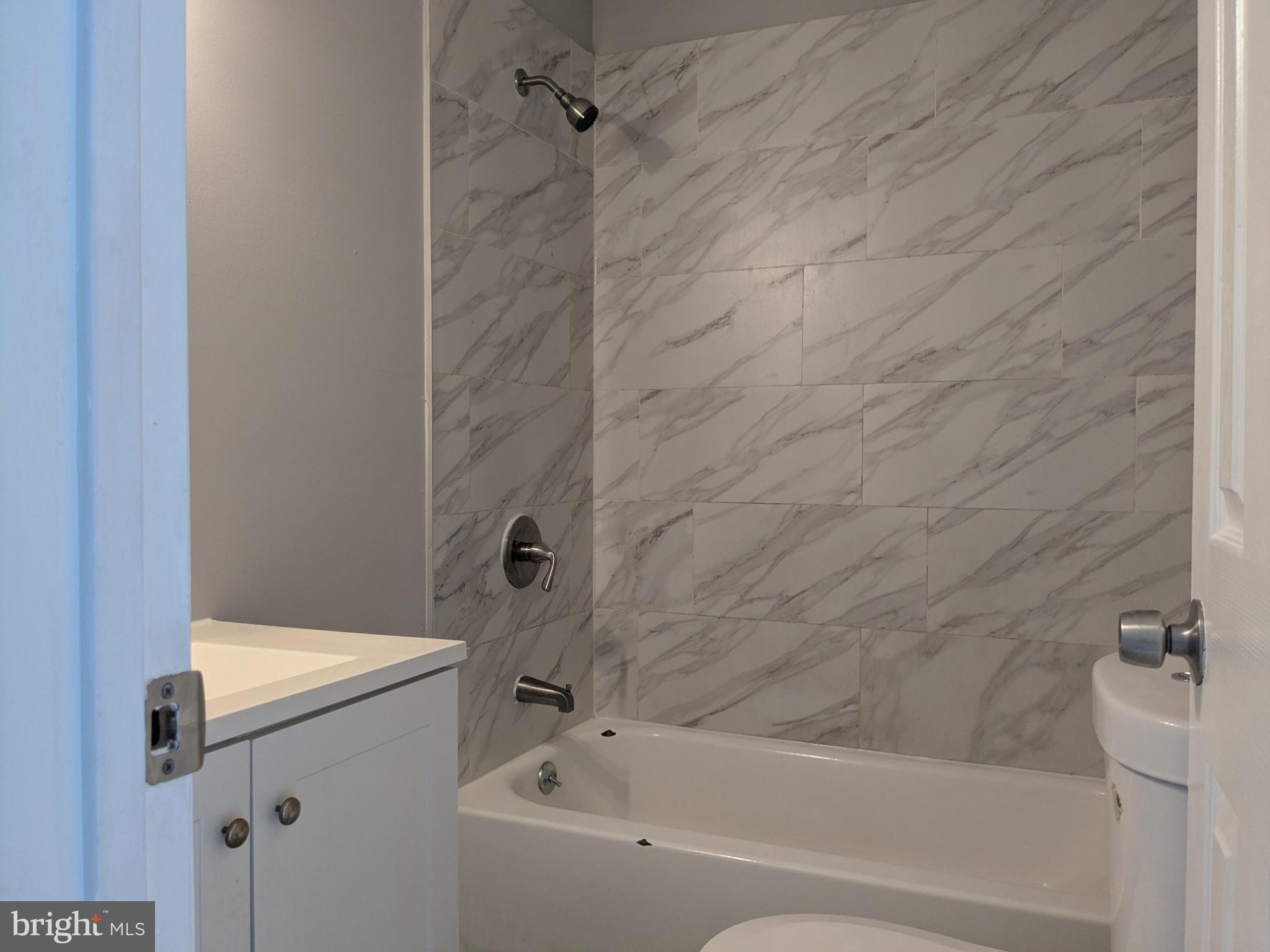 178 178-apt Hanover Street, Unit 2W Trenton, NJ 08618 - Photo 12 of 22 a bathroom with a bathtub