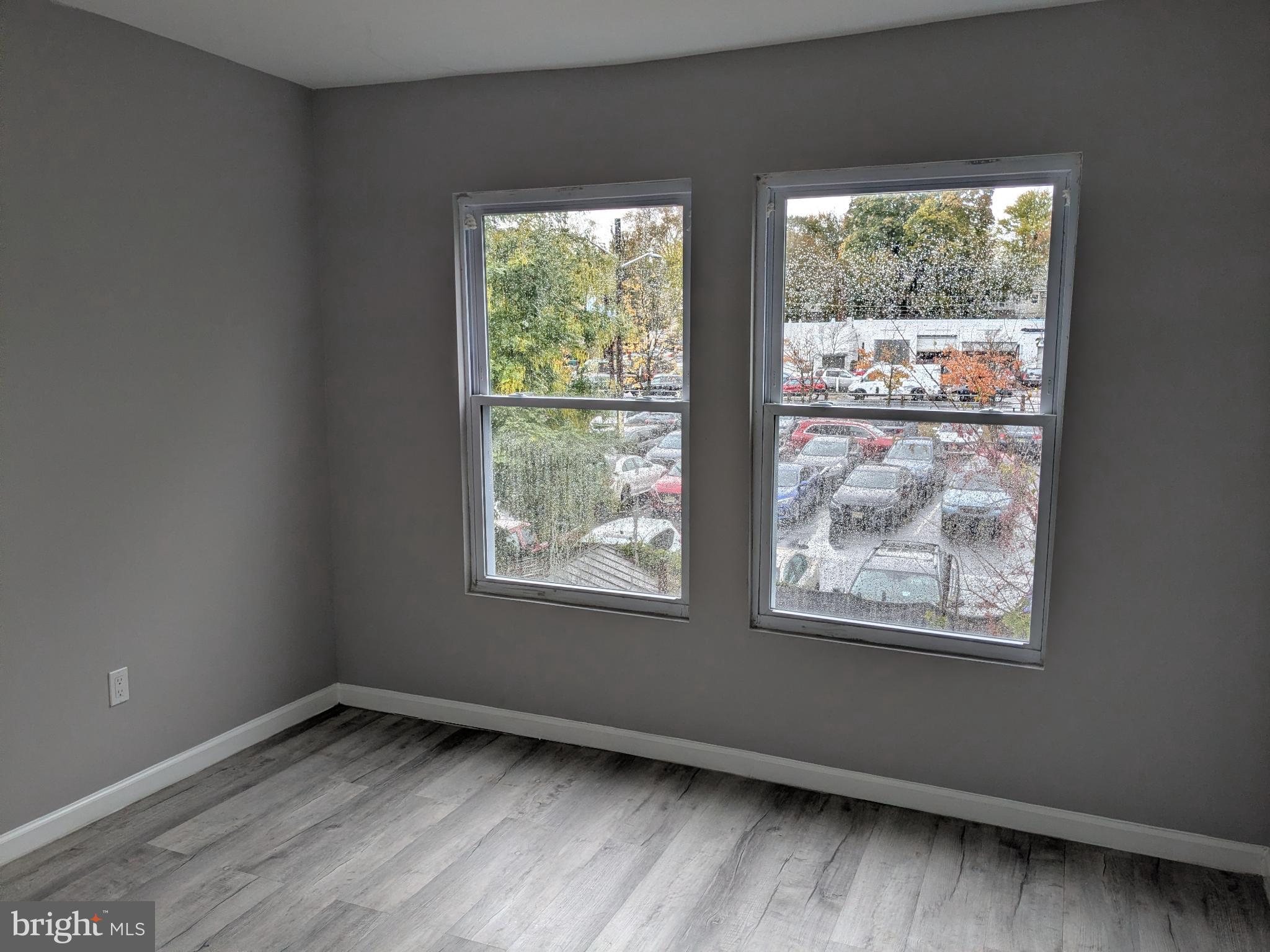 178 178-apt Hanover Street, Unit 2W Trenton, NJ 08618 - Photo 15 of 22 an empty room with wooden floor and windows