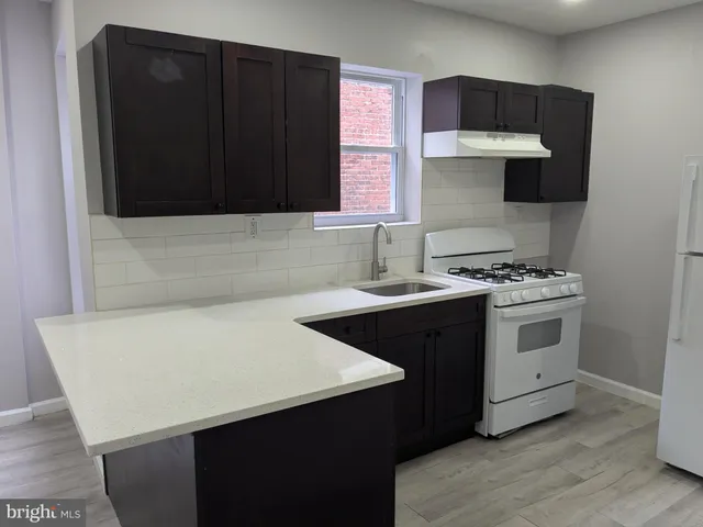 a kitchen with a sink and a stove top oven