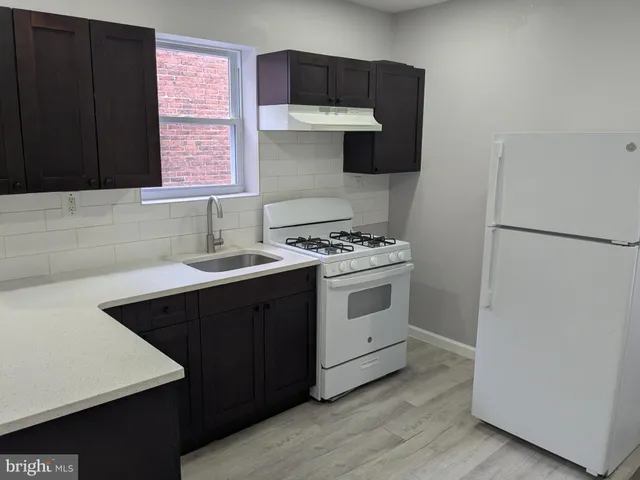 a kitchen with a stove and a refrigerator