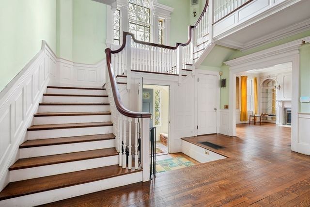 a view of entryway with wooden floor and front door