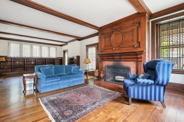 a living room with furniture a rug and a fireplace