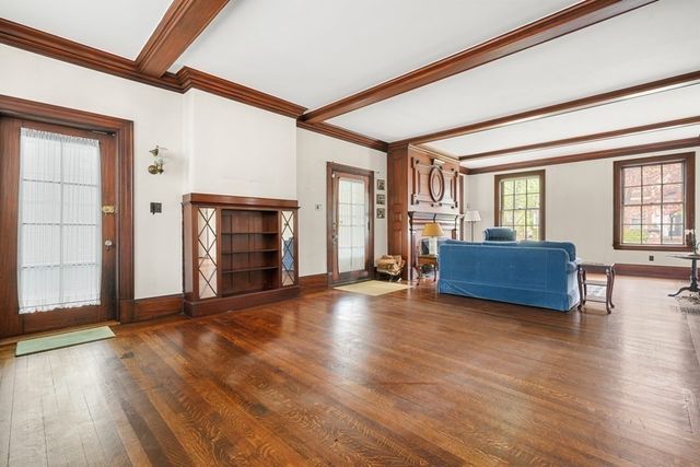 a view of a livingroom with wooden floor and furniture