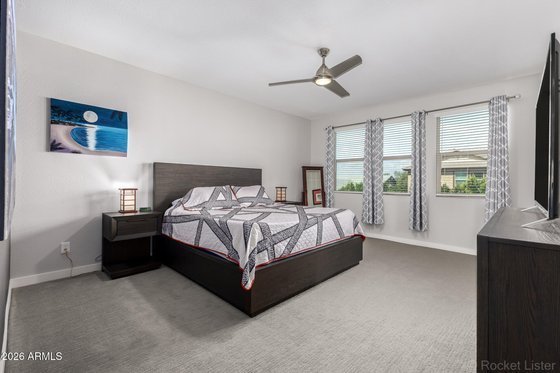 3494 East Spring Wheat Lane Gilbert, AZ 85296 - Photo 18 of 39 a bedroom with a bed lamp and a large window