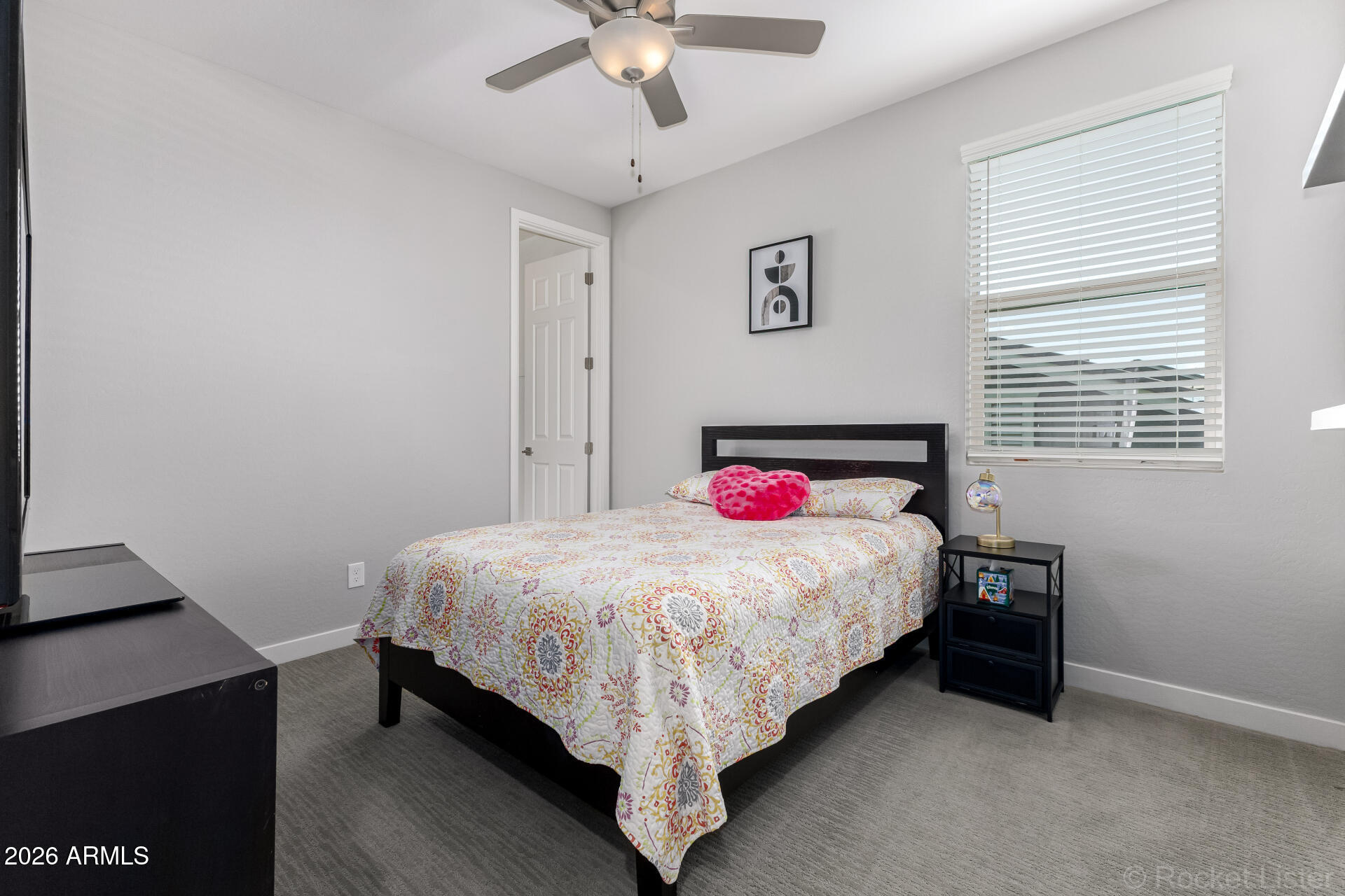 3494 East Spring Wheat Lane Gilbert, AZ 85296 - Photo 24 of 39 a bed sitting in a bedroom next to a window