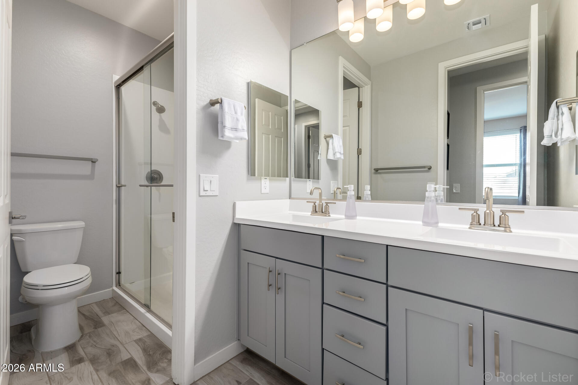 3494 East Spring Wheat Lane Gilbert, AZ 85296 - Photo 27 of 39 a bathroom with a double vanity sink toilet and shower