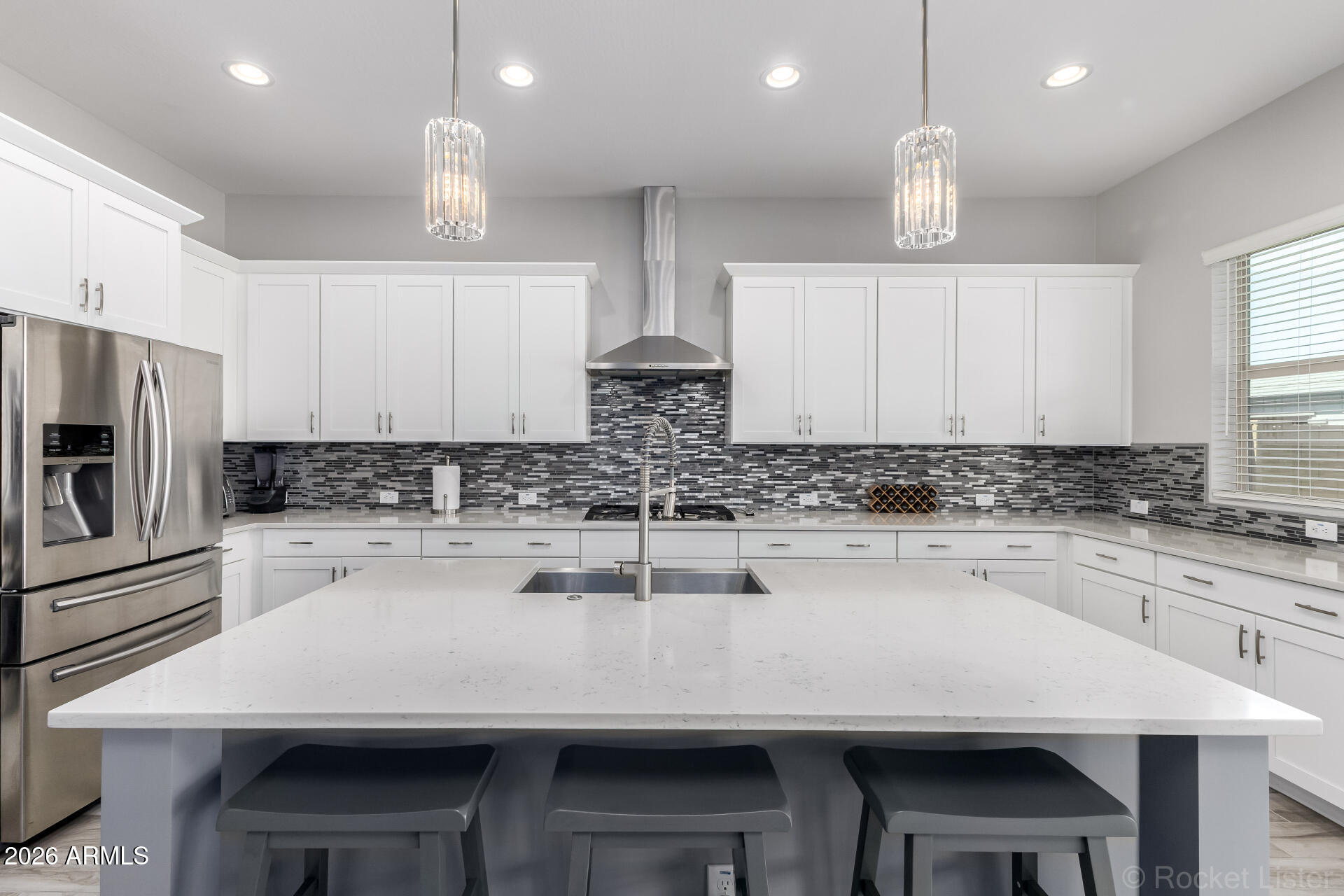 3494 East Spring Wheat Lane Gilbert, AZ 85296 - Photo 5 of 39 a kitchen with a sink stainless steel appliances and white cabinets