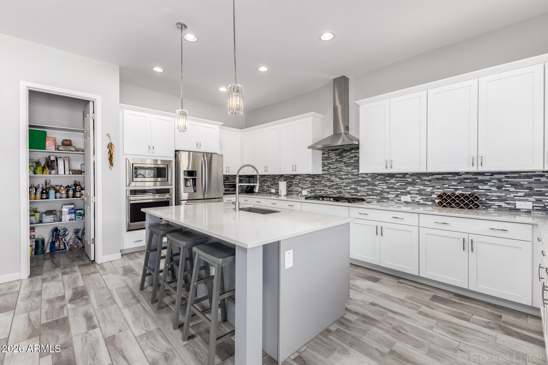 3494 East Spring Wheat Lane Gilbert, AZ 85296 - Photo 6 of 39 a kitchen with stainless steel appliances granite countertop a sink stove and refrigerator