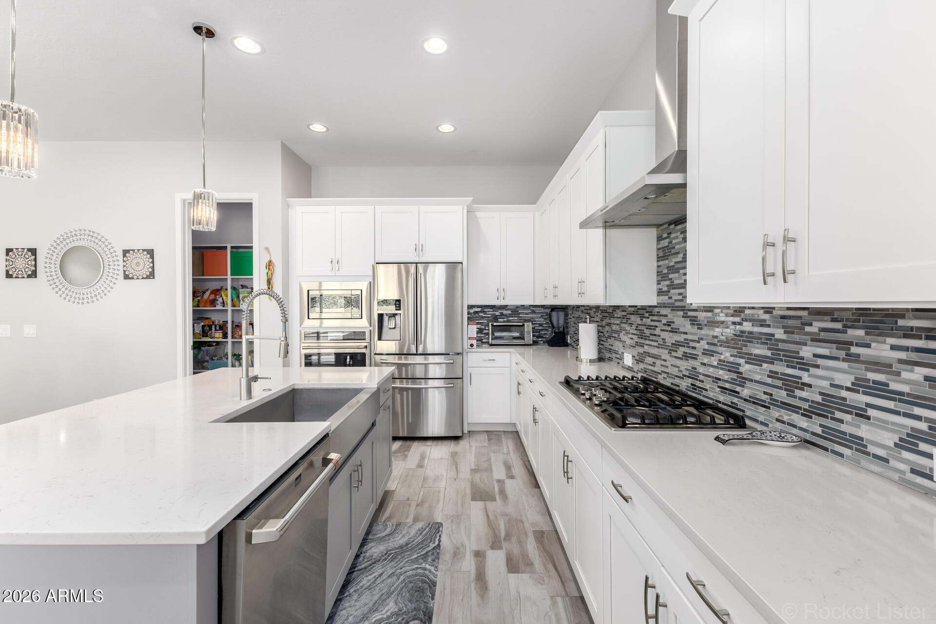 3494 East Spring Wheat Lane Gilbert, AZ 85296 - Photo 7 of 39 a kitchen with stainless steel appliances kitchen island granite countertop a stove and a sink