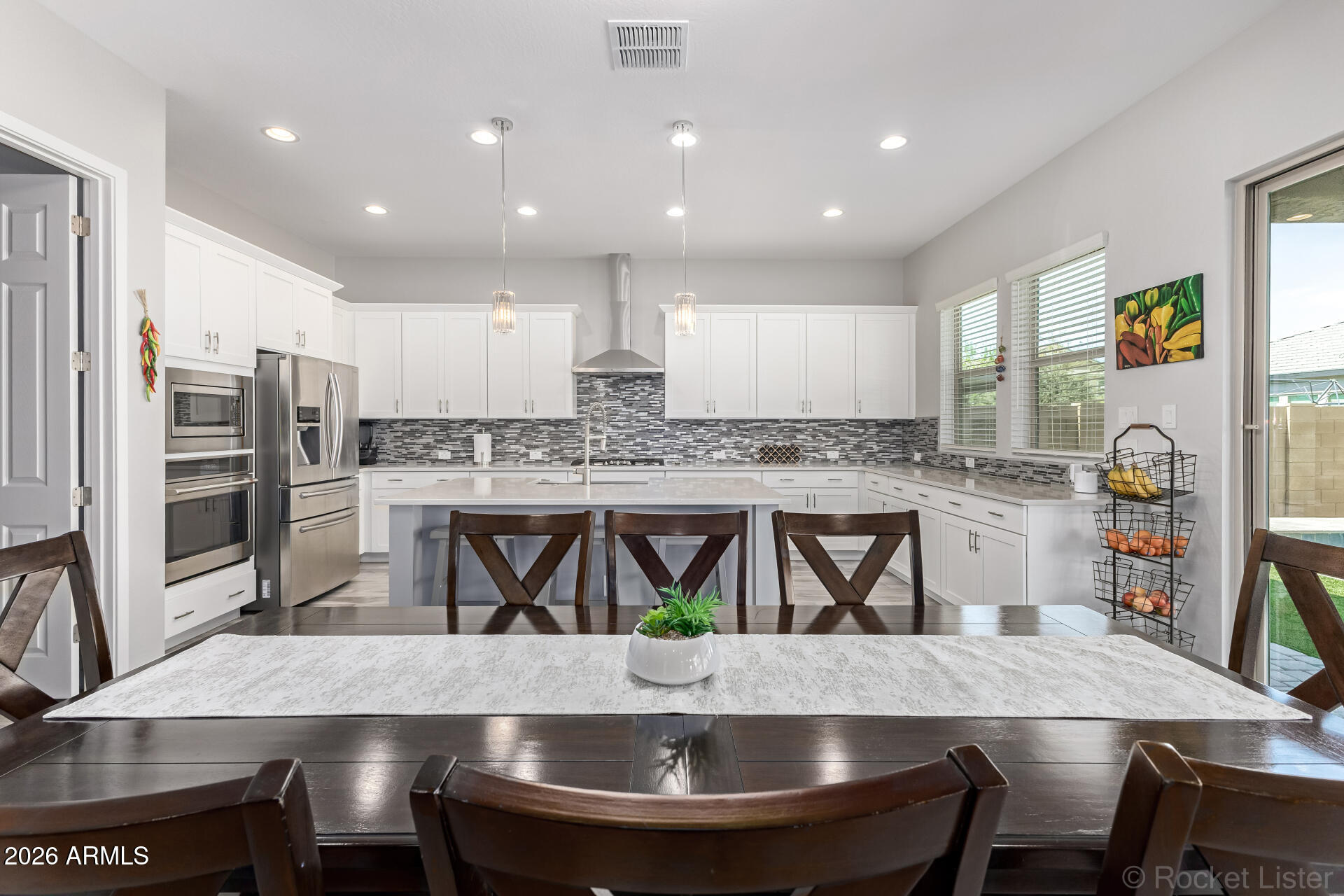 3494 East Spring Wheat Lane Gilbert, AZ 85296 - Photo 8 of 39 a kitchen with a dining table chairs and refrigerator
