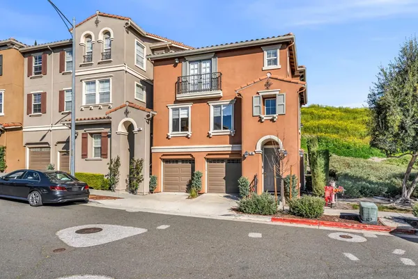 a front view of a residential apartment building with a yard