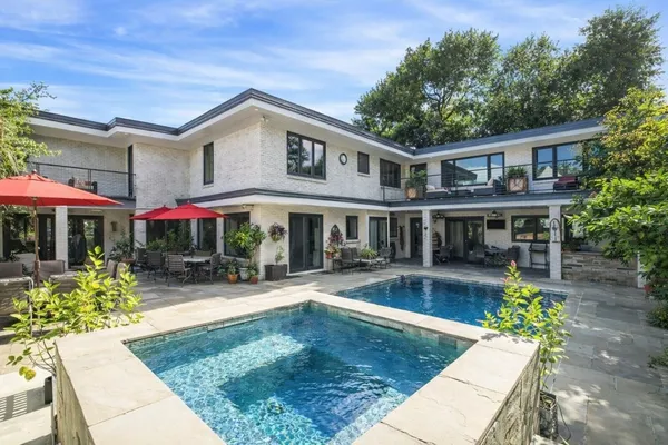 a front view of house with yard swimming pool and outdoor seating