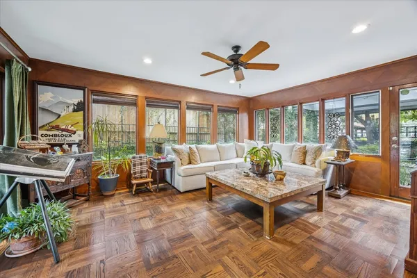 a view of a balcony with couches and wooden floor