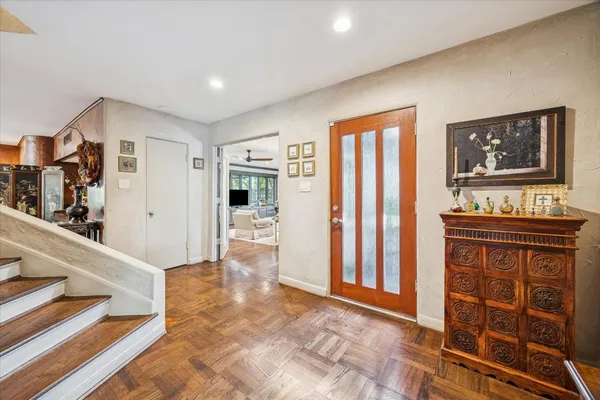 a kitchen with cabinets and wooden floor
