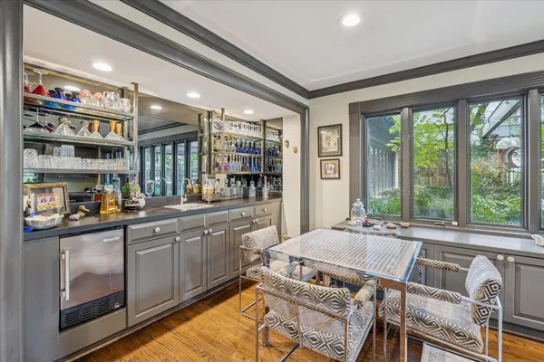 a dining room with furniture a chandelier and pool table