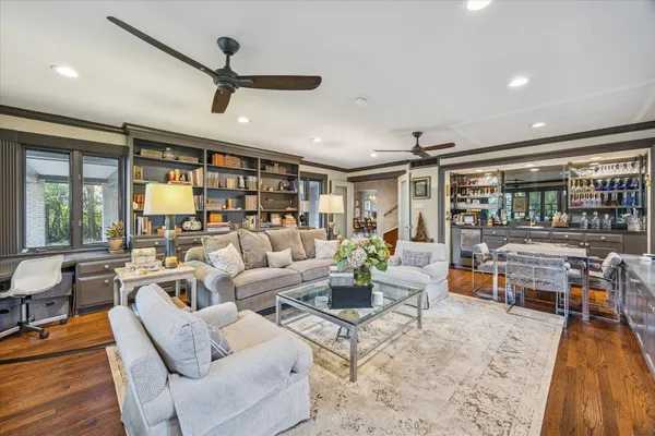 a living room with furniture and wooden floor
