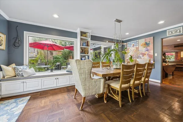a view of house with outdoor seating and a bench