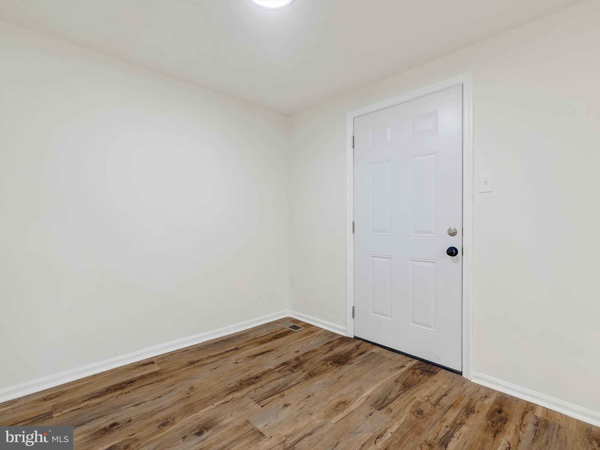 4226 Red Haven Road Baltimore, MD 21208 - Photo 12 of 32 a view of empty room with wooden floor