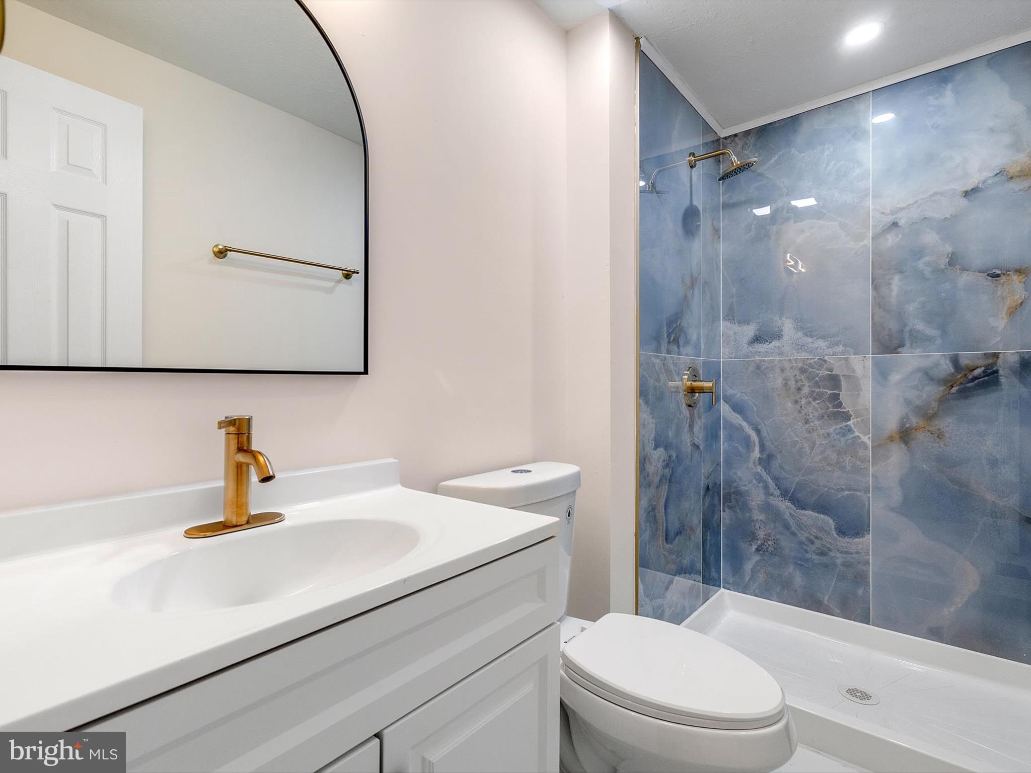 4226 Red Haven Road Baltimore, MD 21208 - Photo 20 of 32 a bathroom with a sink a toilet and shower