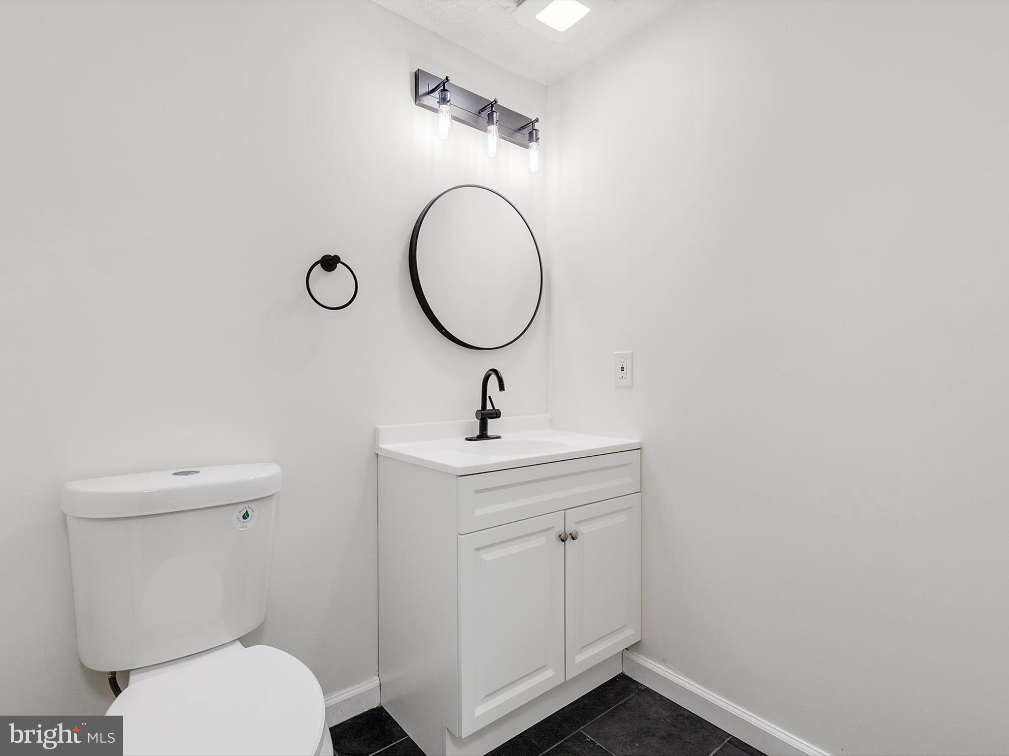 4226 Red Haven Road Baltimore, MD 21208 - Photo 21 of 32 a bathroom with a toilet sink and a mirror