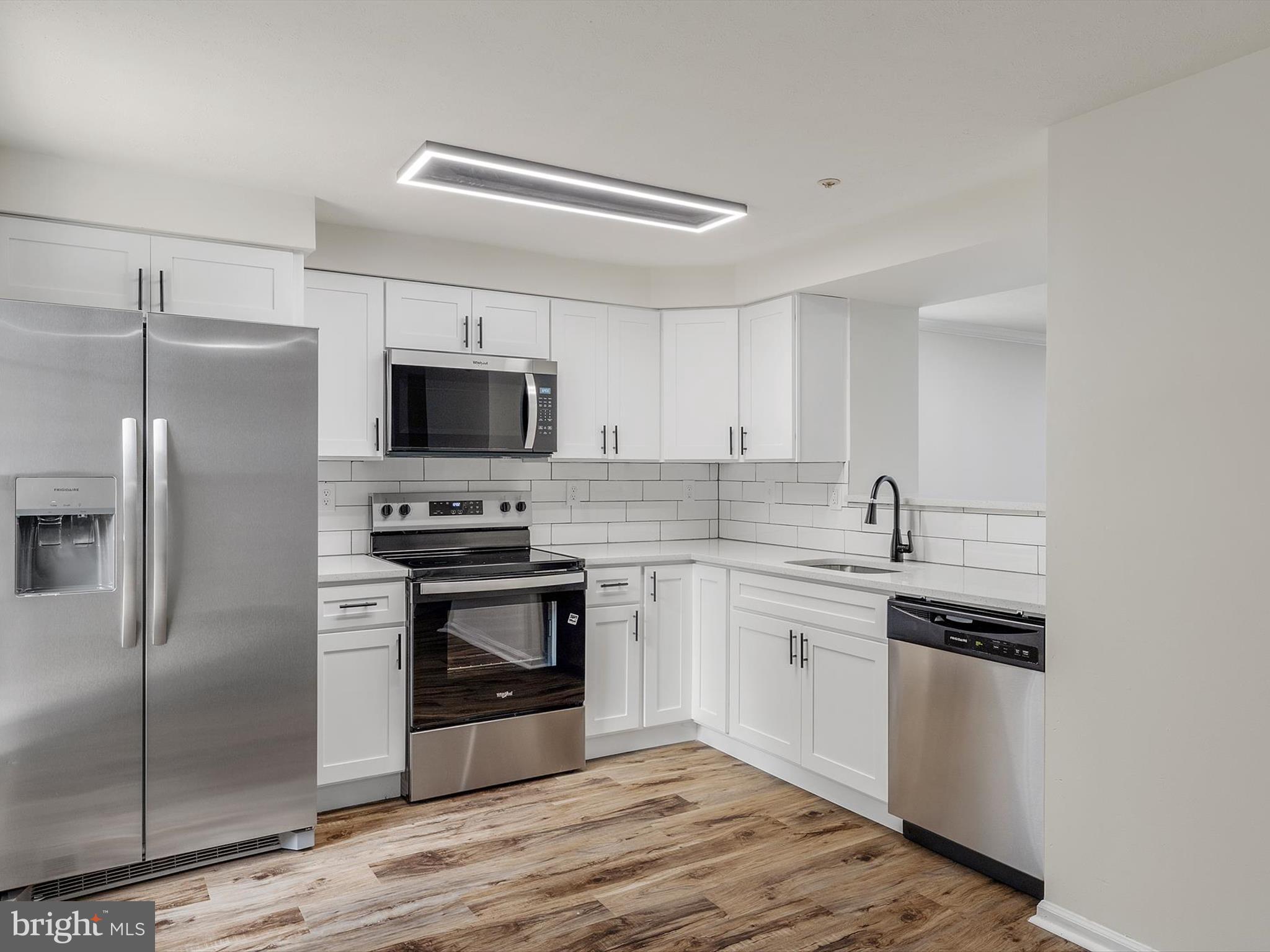 4226 Red Haven Road Baltimore, MD 21208 - Photo 3 of 32 a kitchen with a sink stainless steel appliances and cabinets