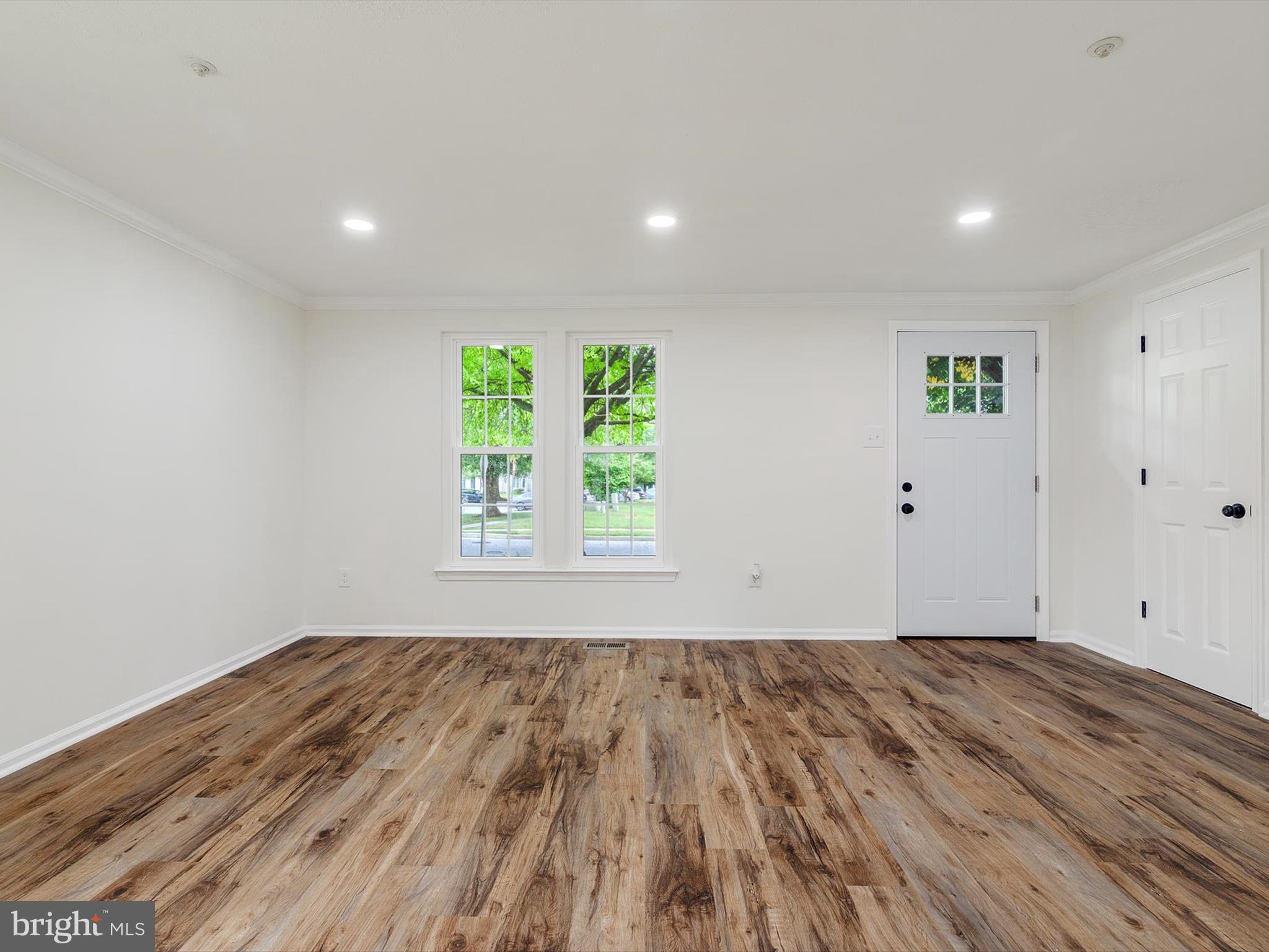 4226 Red Haven Road Baltimore, MD 21208 - Photo 9 of 32 an empty room with wooden floor and windows