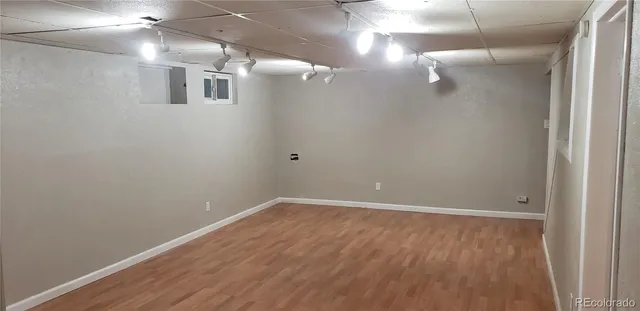 a view of a room with wooden floor