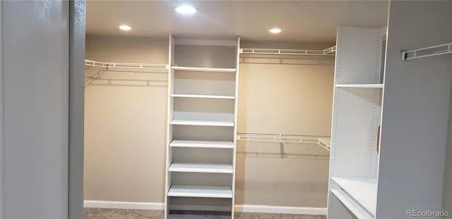 a view of walk in closet with empty racks