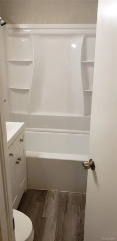 a bathroom with a toilet and a bathtub