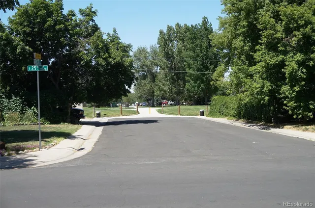 a view of a fountain with large trees