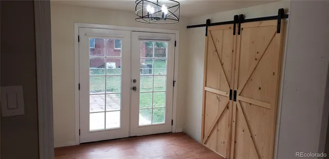 a view of a front door and wooden floor