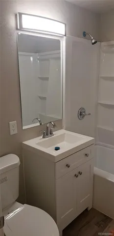 a bathroom with a sink toilet and mirror