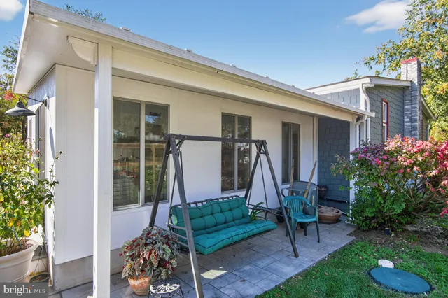 a patio with a patio table and chairs
