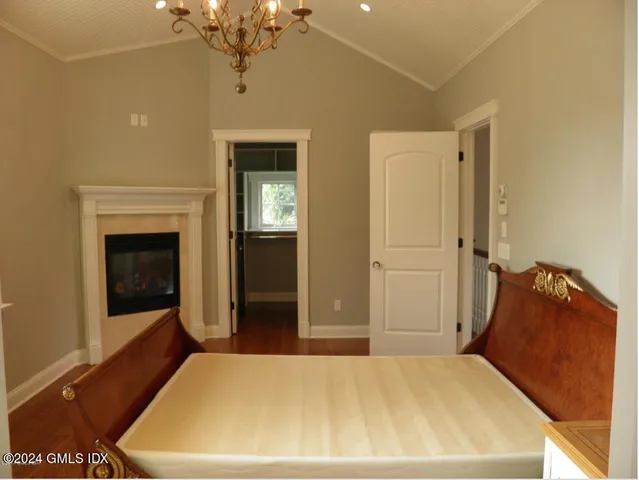 a bed room with a bed and a chandelier