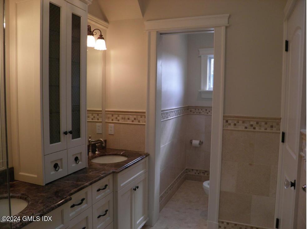 1 Field Road Cos Cob, CT 06807 - Photo 14 of 22 a bathroom with a mirror sink and glass door