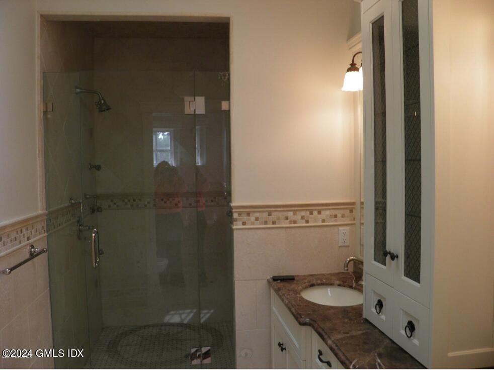 1 Field Road Cos Cob, CT 06807 - Photo 15 of 22 a bathroom with a granite countertop sink a mirror and a shower