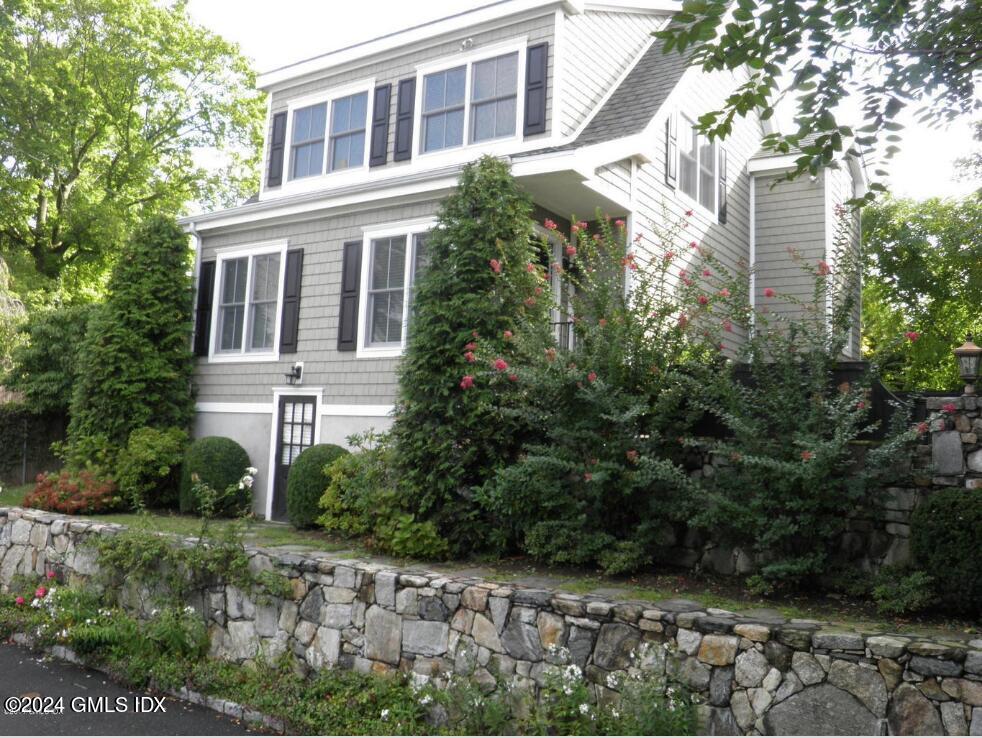 1 Field Road Cos Cob, CT 06807 - Photo 19 of 22 a front view of a house with a garden