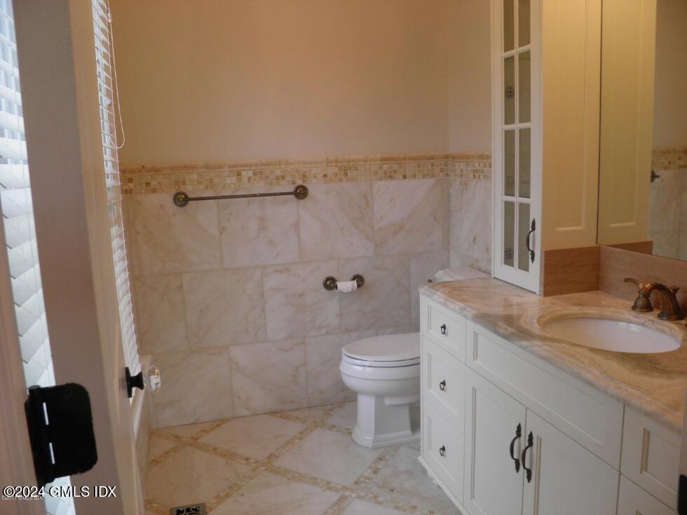 1 Field Road Cos Cob, CT 06807 - Photo 7 of 22 a bathroom with a granite countertop sink toilet and shower