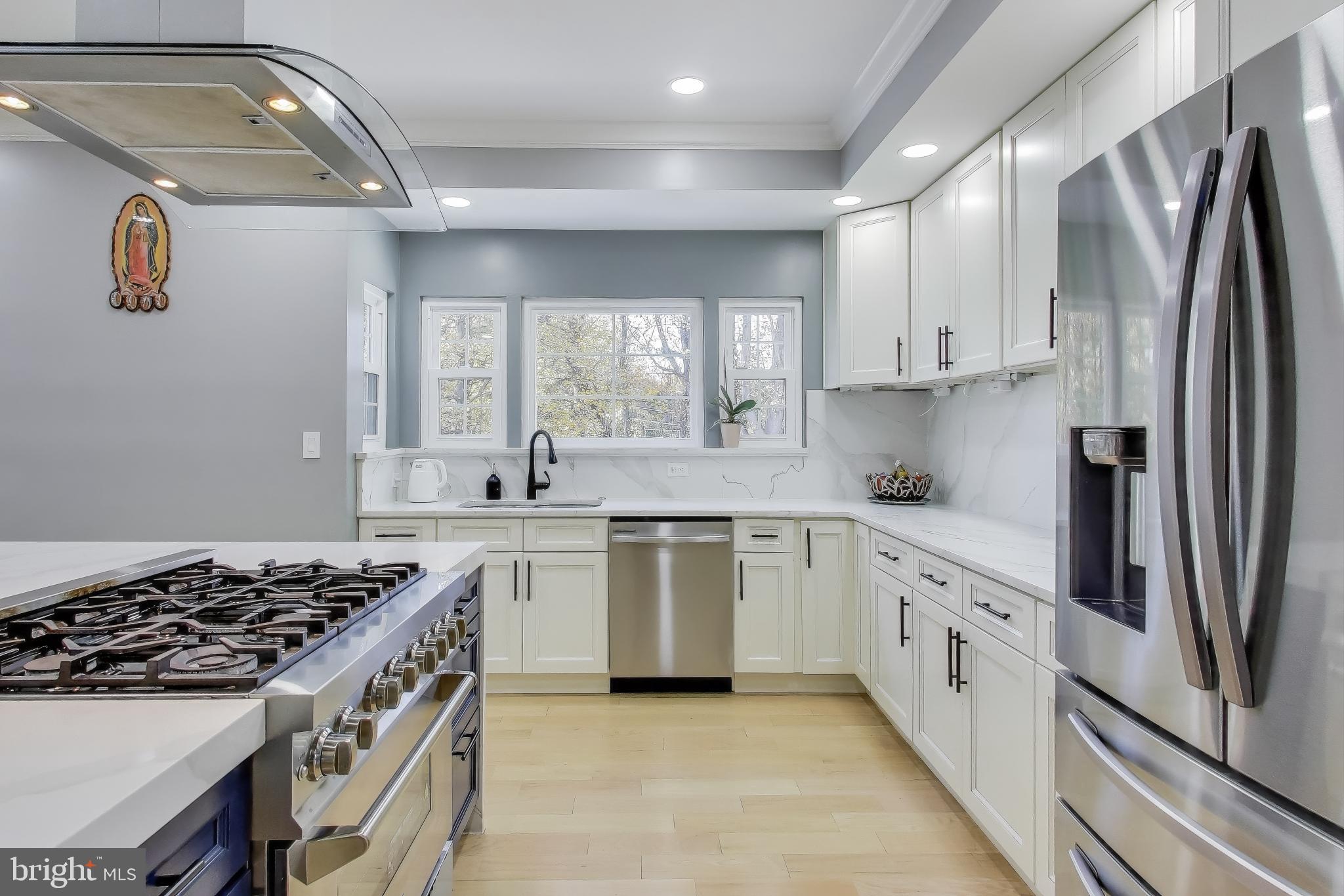 16702 Gooseneck Terrace Olney, MD 20832 - Photo 11 of 65 a kitchen with stainless steel appliances granite countertop a sink stove and refrigerator