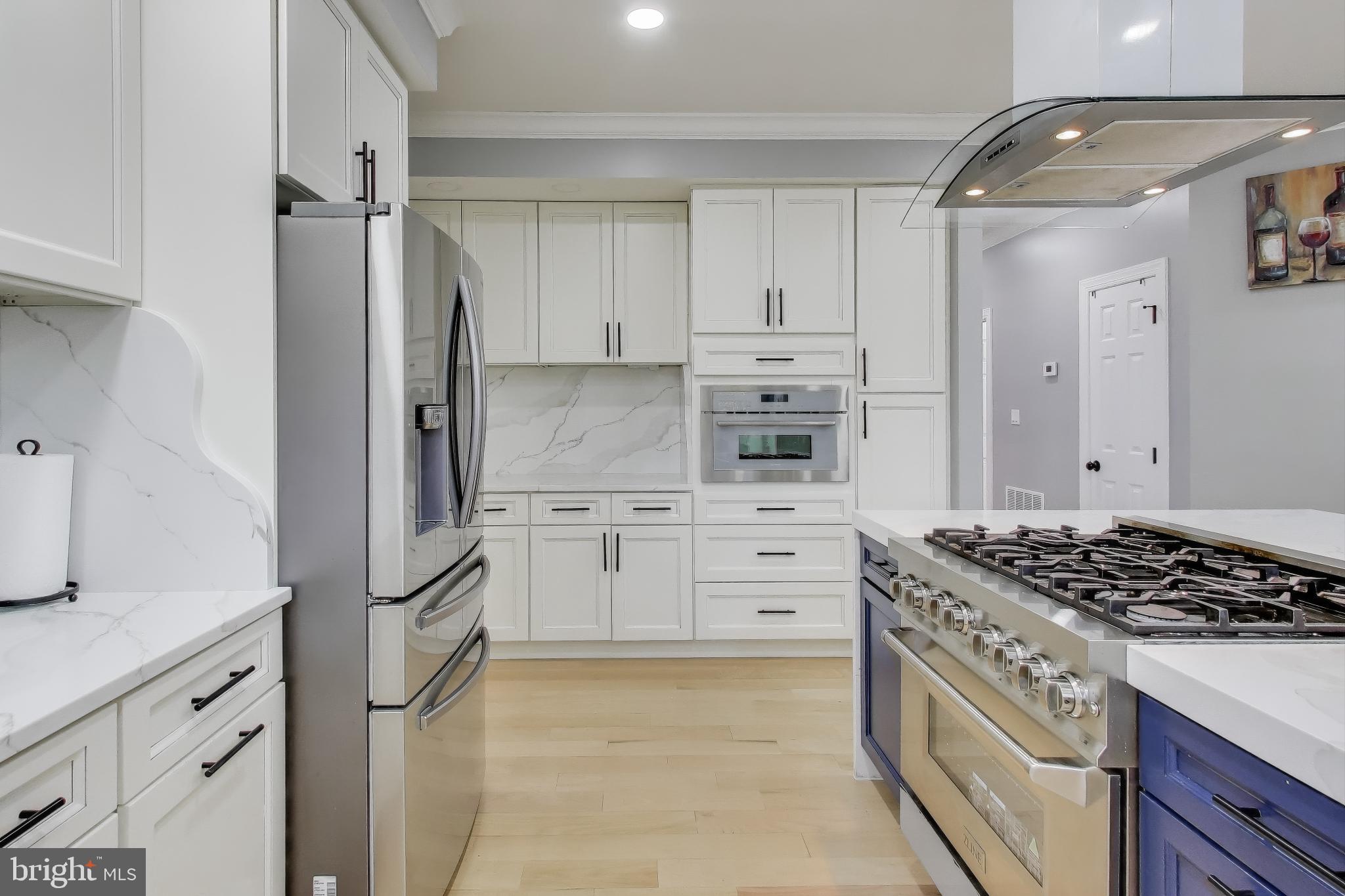 16702 Gooseneck Terrace Olney, MD 20832 - Photo 13 of 65 a kitchen with stainless steel appliances a refrigerator stove and white cabinets