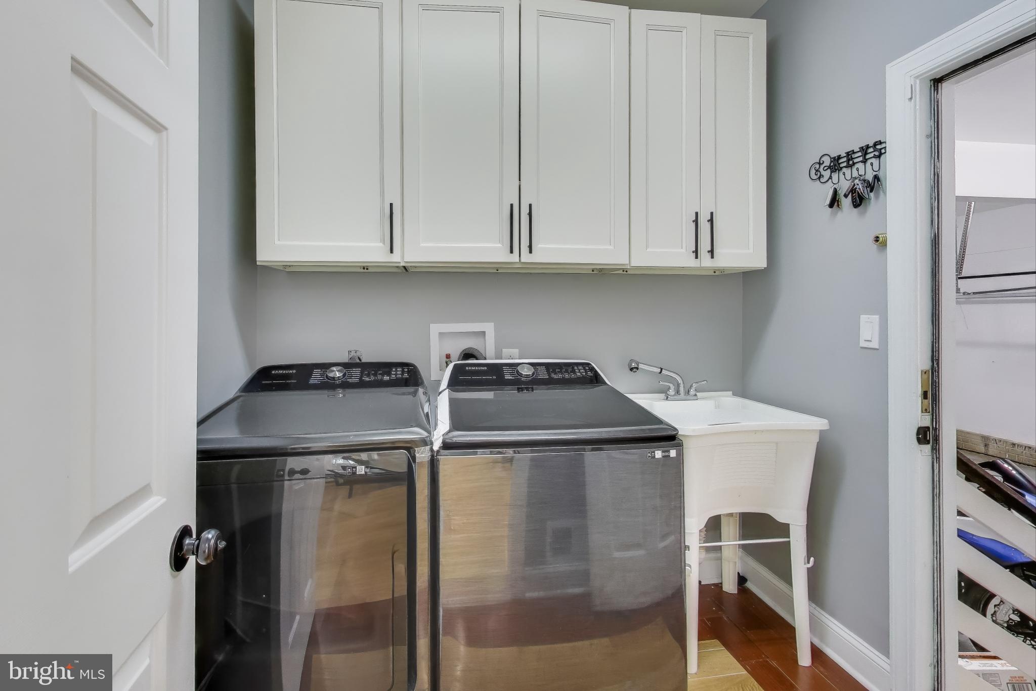 16702 Gooseneck Terrace Olney, MD 20832 - Photo 24 of 65 a utility room with cabinets washer and dryer
