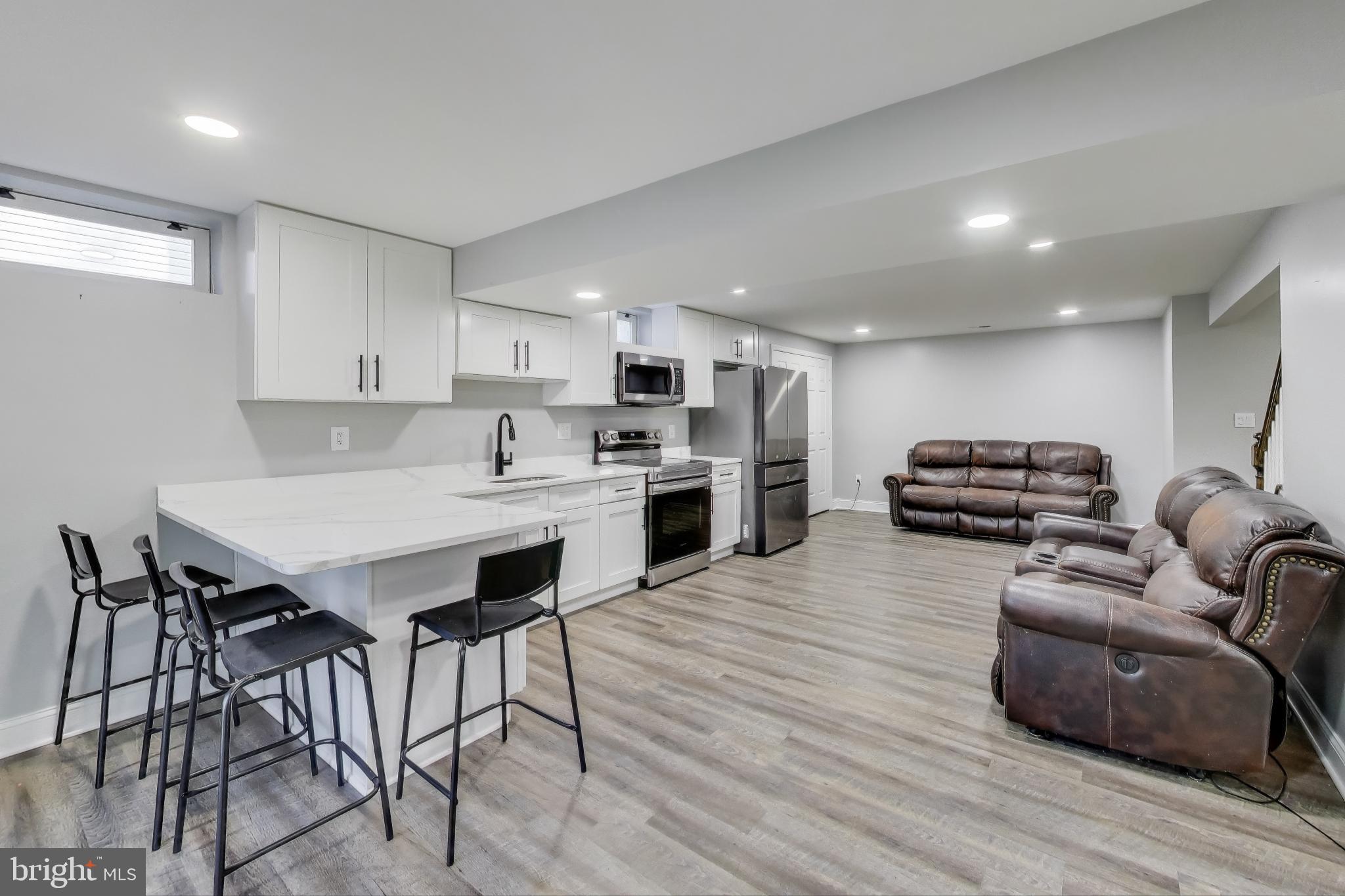 16702 Gooseneck Terrace Olney, MD 20832 - Photo 42 of 65 a living room with furniture and a wooden floor
