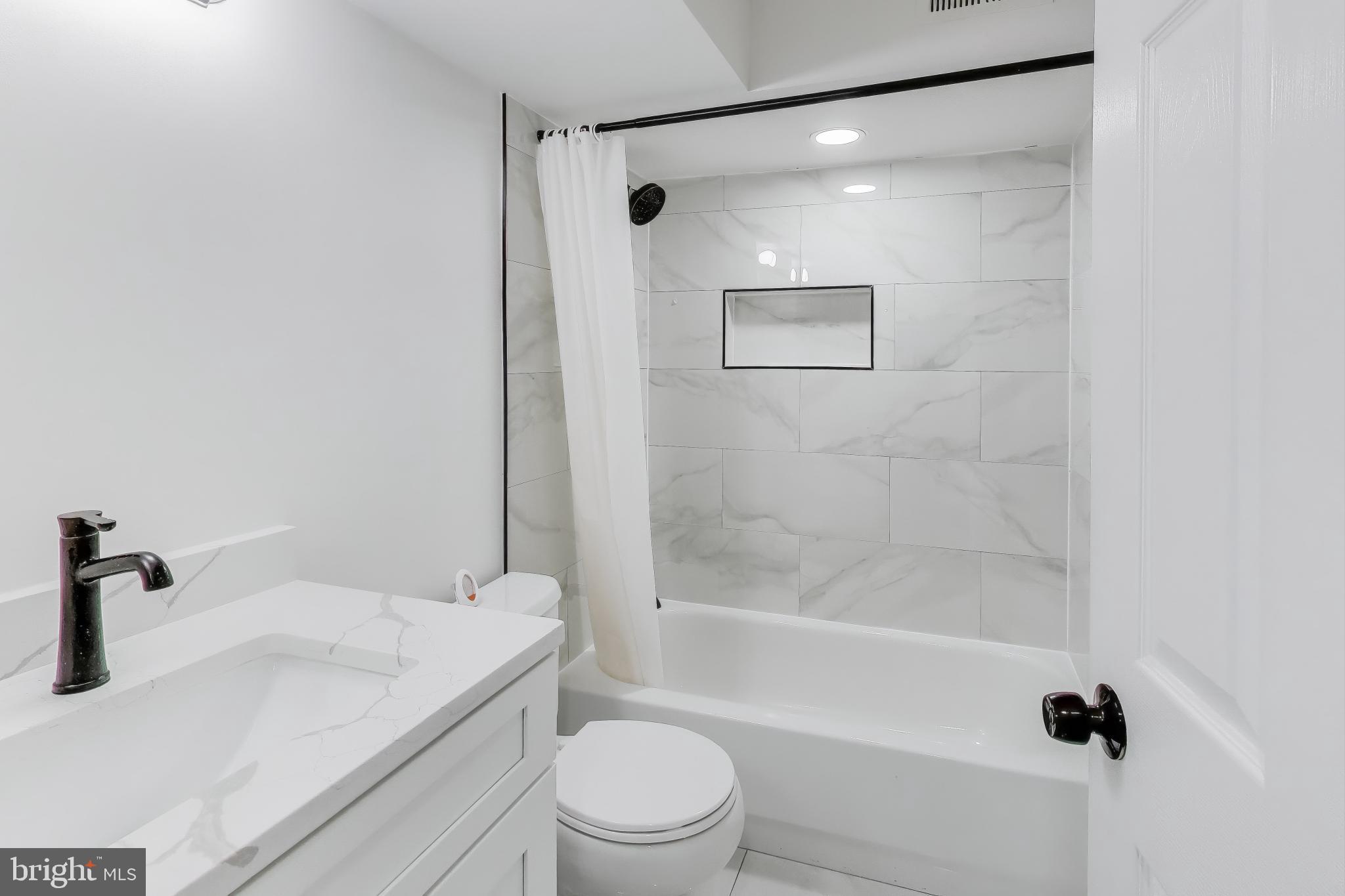 16702 Gooseneck Terrace Olney, MD 20832 - Photo 50 of 65 a bathroom with a granite countertop sink a toilet and shower