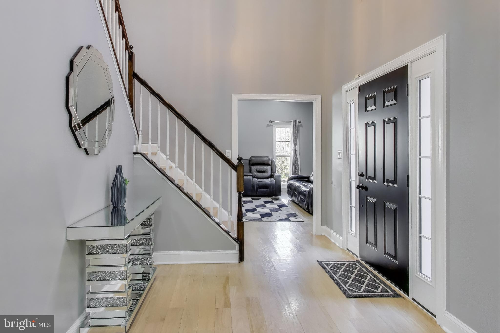 16702 Gooseneck Terrace Olney, MD 20832 - Photo 5 of 65 a view of a hallway with wooden floor and staircase