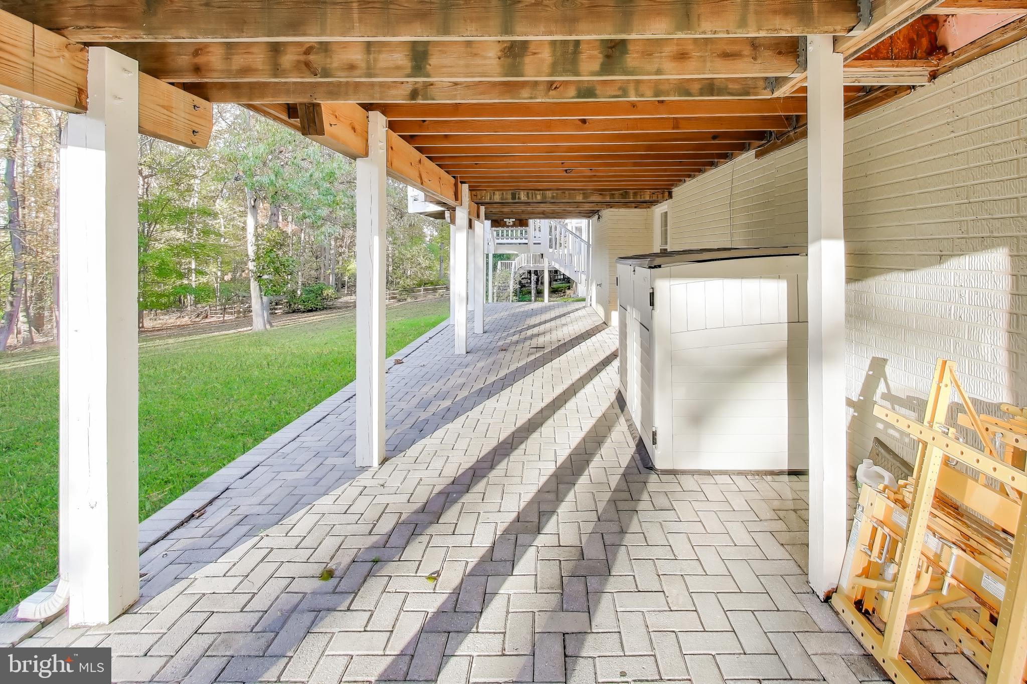 16702 Gooseneck Terrace Olney, MD 20832 - Photo 55 of 65 a view of a porch with wooden floor and iron stairs