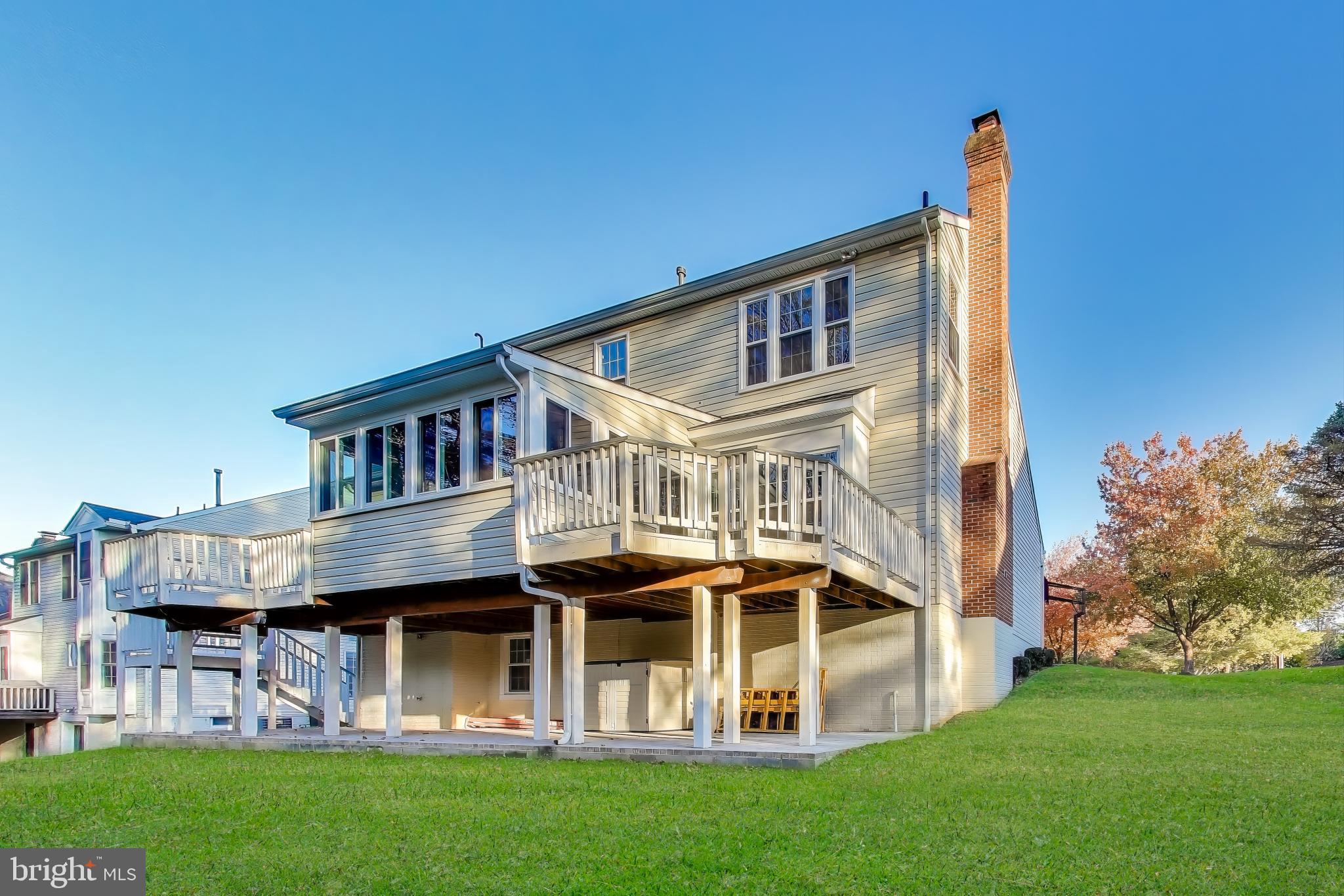16702 Gooseneck Terrace Olney, MD 20832 - Photo 59 of 65 a front view of a house with a yard table and chairs